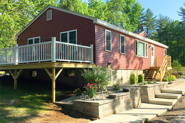 A red assisted living facility with a deck
